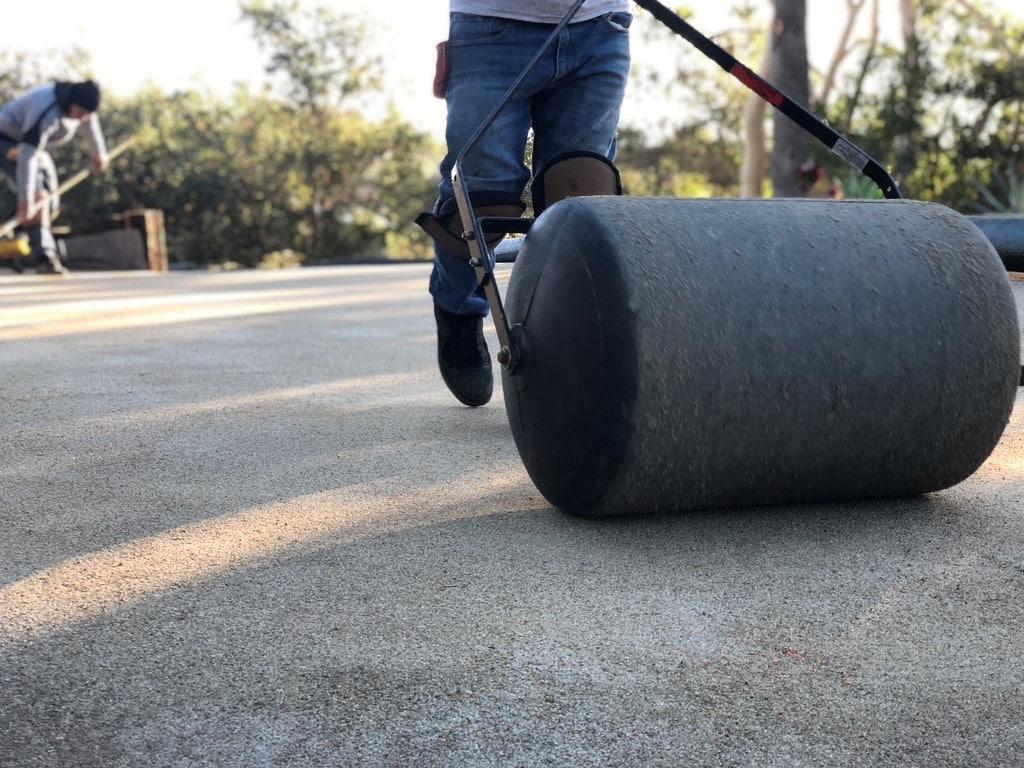 Professionals installing a base for synthetic turf